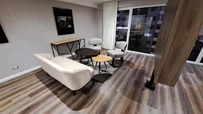 a living room with a white couch and chairs at Equo Hotel Boutique in Lima