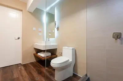 a bathroom with a toilet and a sink and a shower at Equo Hotel Boutique in Lima