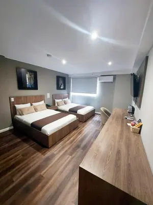 a hotel room with two beds and a table at Equo Hotel Boutique in Lima