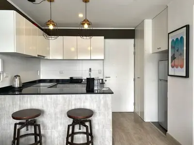 a kitchen with two bar stools and a counter at Osma by Wynwood House in Lima