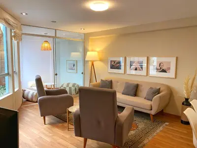 a living room with a couch and two chairs at Nomad By Wynwood House in Lima