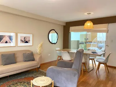 a living room with a couch and a table at Nomad By Wynwood House in Lima