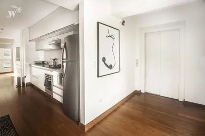 a kitchen with white walls and a refrigerator at Las Mimosas by Wynwood House in Lima