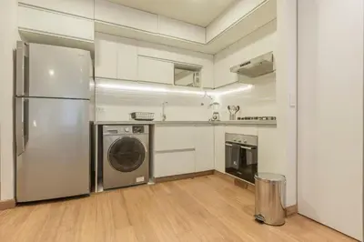 a kitchen with a refrigerator and a dishwasher at Las Mimosas by Wynwood House in Lima