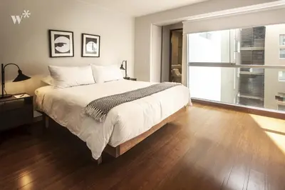 a bedroom with a large bed and a large window at Las Mimosas by Wynwood House in Lima