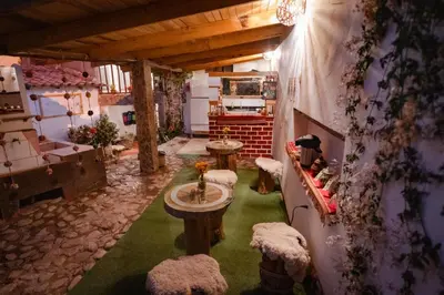 a room with two tables and chairs in a room at MAMA GREEN HOSTAL - Eco Andean Experience and Permaculture Farm - Vegetarian Breakfast in Urubamba