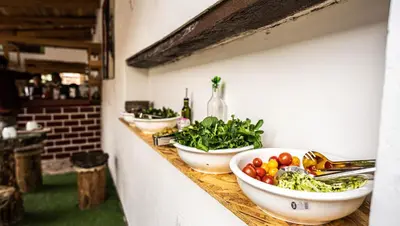 a counter with three bowls of vegetables on it at MAMA GREEN HOSTAL - Eco Andean Experience and Permaculture Farm - Vegetarian Breakfast in Urubamba