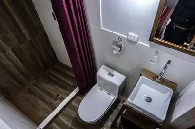 a small bathroom with a toilet and a sink at MAMA GREEN HOSTAL - Eco Andean Experience and Permaculture Farm - Vegetarian Breakfast in Urubamba