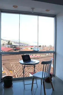 a laptop sitting on a table in front of a window at Casa del Escultor in Cusco