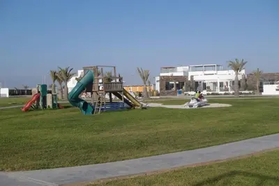 a playground with a slide in a park at PARACAS megaview bayfront flat in Paracas