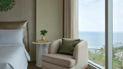 a bedroom with a bed and a chair and a window at SOUMA Hotel, Vignette Collection by IHG in Lima