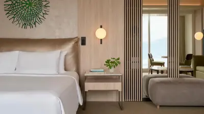 a hotel room with a bed and a chair at SOUMA Hotel, Vignette Collection by IHG in Lima