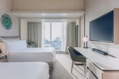 a hotel room with two beds and a flat screen tv at SOUMA Hotel, Vignette Collection by IHG in Lima