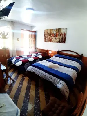 a bedroom with two beds in a room at HOSPEDAJE CENTRAL in Ayacucho