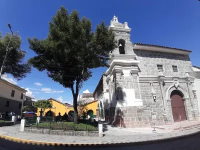 an old church with a tree in front of it at HOSPEDAJE CENTRAL in Ayacucho