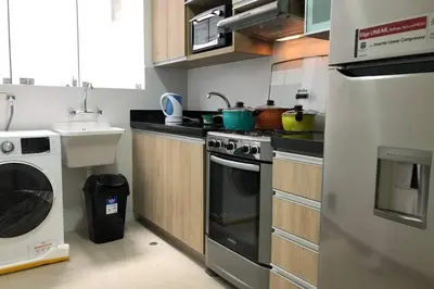 a kitchen with a stove and a washing machine at 6 - Departamento de 2 dormitorios en area turistica de Miraflores in Lima