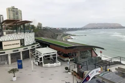 a building next to the ocean next to the water at 7-Departamento moderno en el área turística de Miraflores in Lima