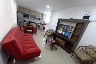 a living room with a red couch and a tv at (5)Modern Miraflores tourist area apartment in Lima