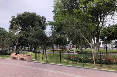 a park with benches and a fence and flowers at (5)Modern Miraflores tourist area apartment in Lima