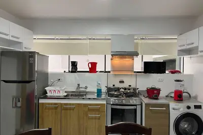a kitchen with a stove and a stove top oven at (4)Acogedor departamento, excelente ubicación in Lima