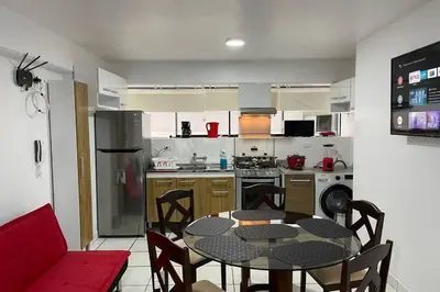 a kitchen with a table and chairs in a kitchen at (4)Acogedor departamento, excelente ubicación in Lima