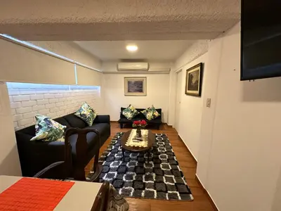 a living room with a couch and a table at 2- Amplio Departamento remodelado en Miraflores in Lima