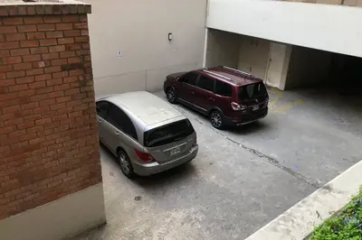 two cars are parked in a parking garage at 4B Mini-departamento nuevo en centro de Miraflores in Lima