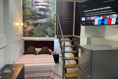 a small room with a bed and a staircase at 4B Mini-departamento nuevo en centro de Miraflores in Lima