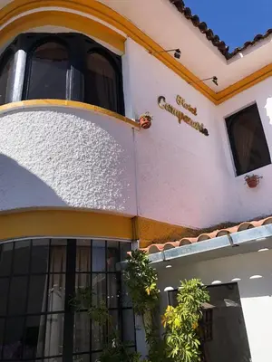 a building with a sign on the side of it at Hotel Campanario in Cusco