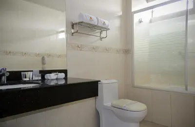 a bathroom with a toilet and a sink at Kingdom Hotel in Lima