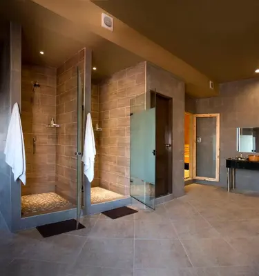 a large bathroom with a shower and a walk in shower at Kingdom Hotel in Lima