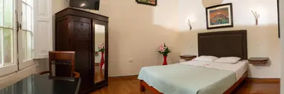 a small bedroom with a bed and a dresser at Hospedaje Santa Rosa- Centro Histórico in Lima