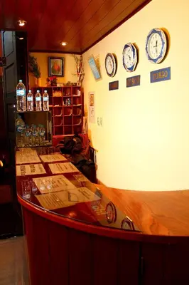 a room with clocks on the wall and a counter at Hostal Alfredo's Palace in Cusco