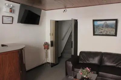 a living room with a couch and a television at Hostal Alfredo's Palace in Cusco