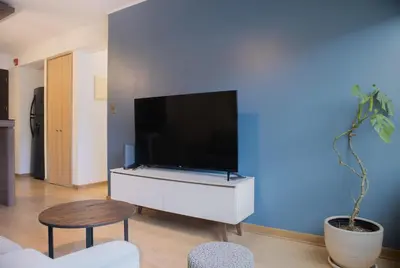 a living room with a large flat screen tv on a wall at Martinto 114 by Wynwood House in Lima