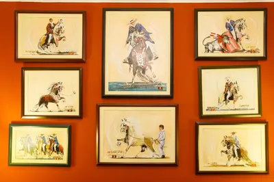 a wall filled with framed pictures of horses at Casa Suyay in Lima