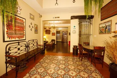 a living room with a bed and a table and chairs at Casa Suyay in Lima