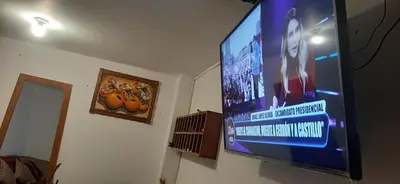 a flat screen tv hanging on a wall at Quipu Hostal in Machu Picchu
