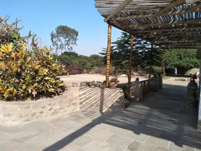 a patio with a fence and some plants at Huaranjapo in El Carmen