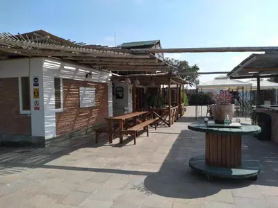 a patio with benches and tables on a building at Huaranjapo in El Carmen