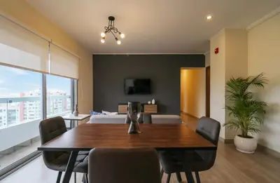 a dining room with a table and chairs and a bed at Reducto 825 by Wynwood House in Lima