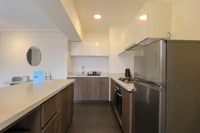 a large kitchen with a stainless steel refrigerator at Reducto 825 by Wynwood House in Lima