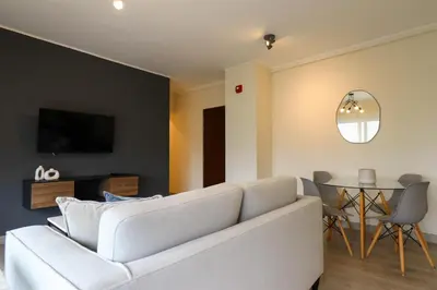 a living room with a white couch and a table at Reducto 825 by Wynwood House in Lima