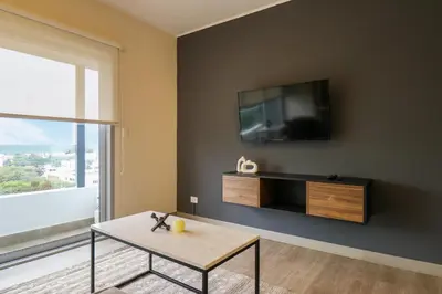 a living room with a tv and a coffee table at Reducto 825 by Wynwood House in Lima