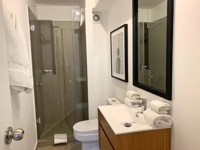 a bathroom with a toilet and a sink and a shower at Primera Parada By Wynwood House in Lima