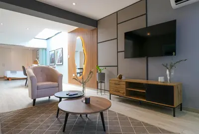 a living room with a flat screen tv on a wall at Primera Parada By Wynwood House in Lima