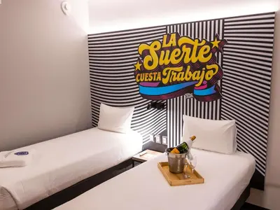 two beds in a room with a sign on the wall at ibis styles Lima San Isidro in Lima