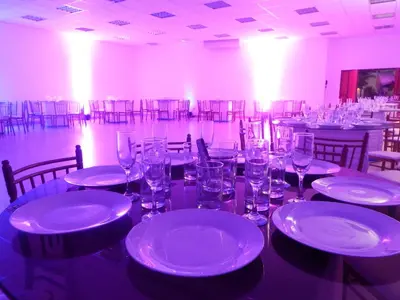 a room with tables and chairs with white plates and glasses at Qala Hotels & Resorts in Chincha Alta