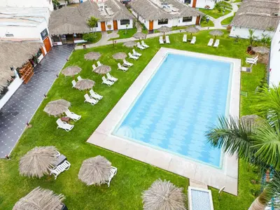 an overhead view of a pool with lawn chairs and umbrellas at Qala Hotels & Resorts in Chincha Alta