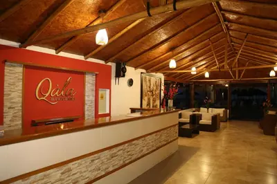 a restaurant with a bar with a red wall at Qala Hotels & Resorts in Chincha Alta